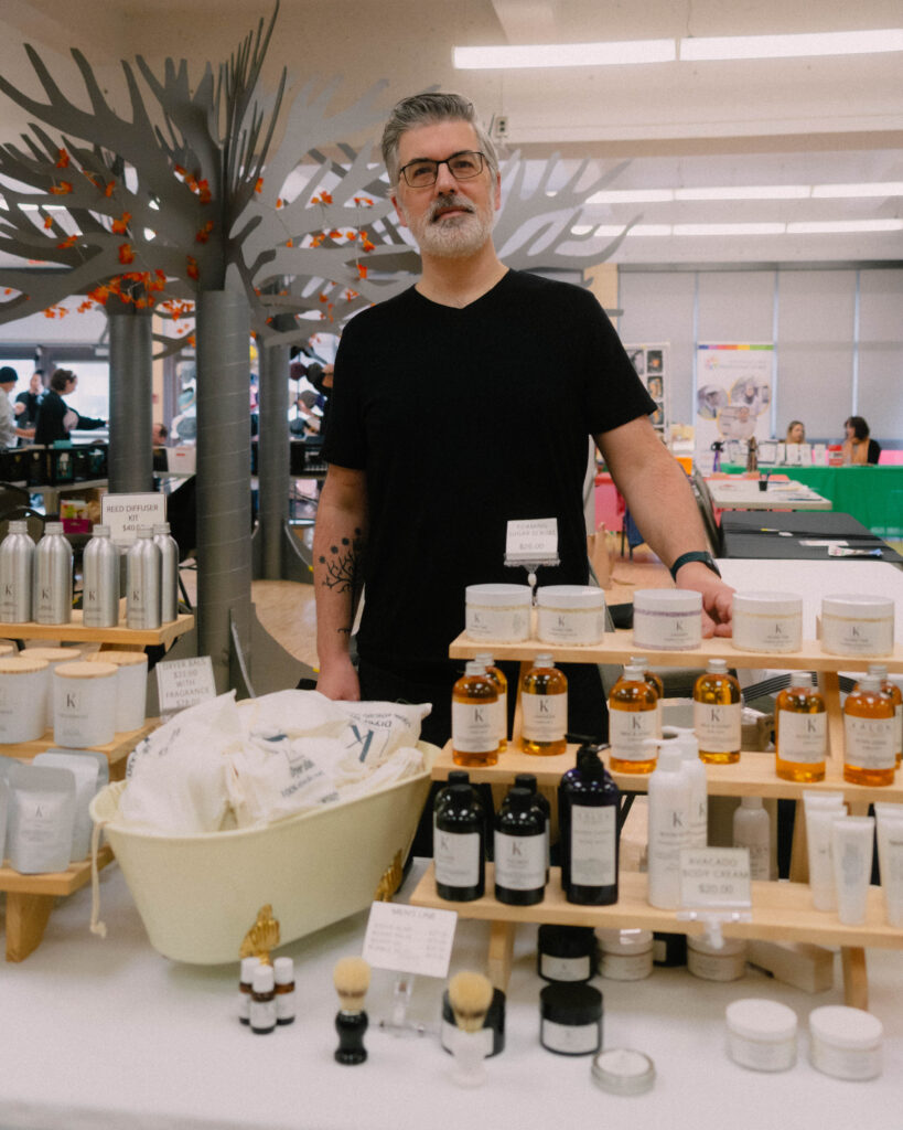 Market participant presenting handmade soap, highlighting local craftsmanship, as he participate in the Maple Sugar Festival Market.