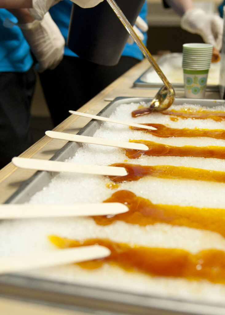 Photograph of a snow bank with maple syrup poured on top to make maple toffee.