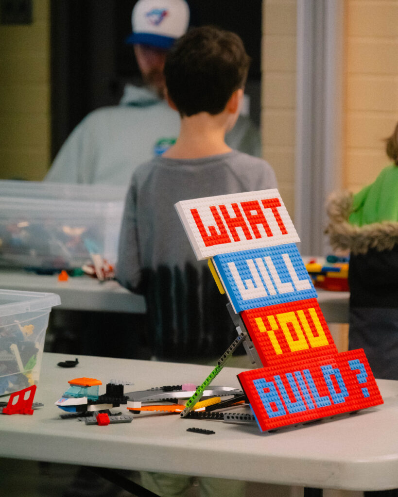 Photo of kids building and playing together with LEGO pieces at the festival.