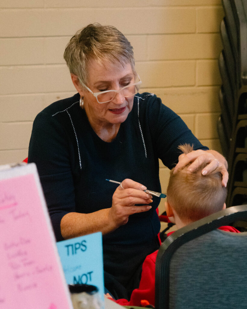 Photo of a child getting their face painted at the festival.