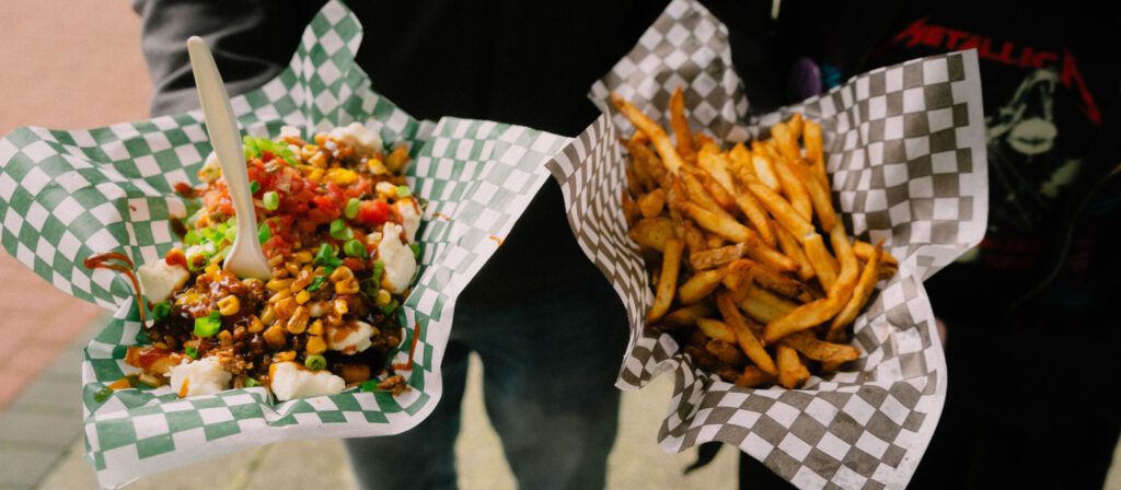 Photo of two fancy poutine dishes at the Maple Sugar Festival food, ready to be enjoyed by festival-goers.