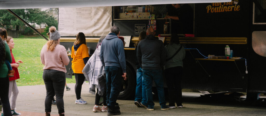 Photo of festival-goers lined up for the Vanisle Poutinerie food truck at the Maple Sugar Festival.