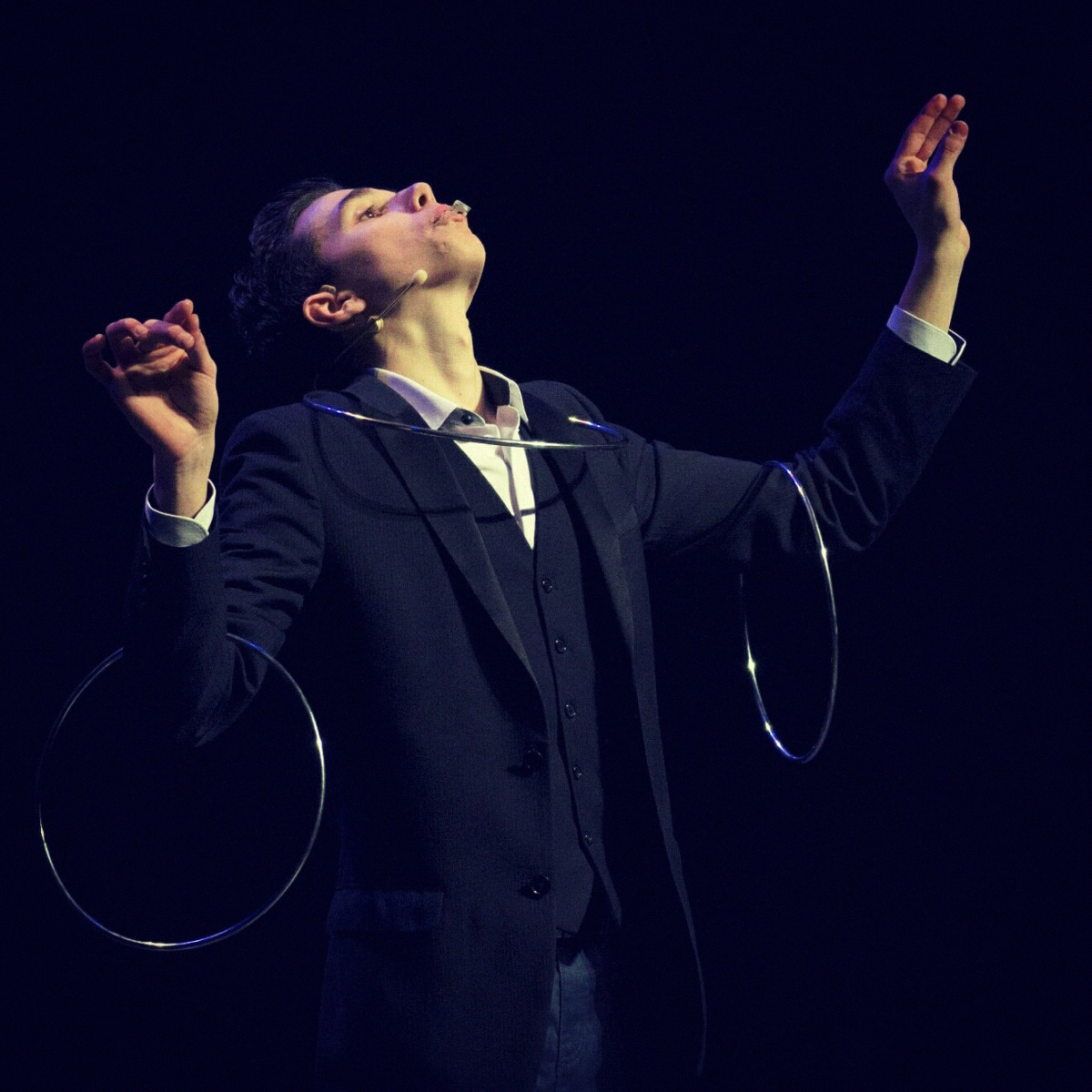 A magician performing on stage.
