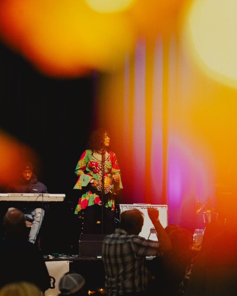 Photograph of the Maple Sugar Festival ambiance, with artist on stage and people dancing.